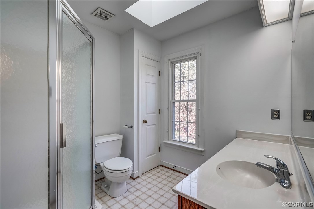6205 Lansgate Road Midlothian, VA 23112 - Photo 41 of 50 a bathroom with a toilet a sink and a window