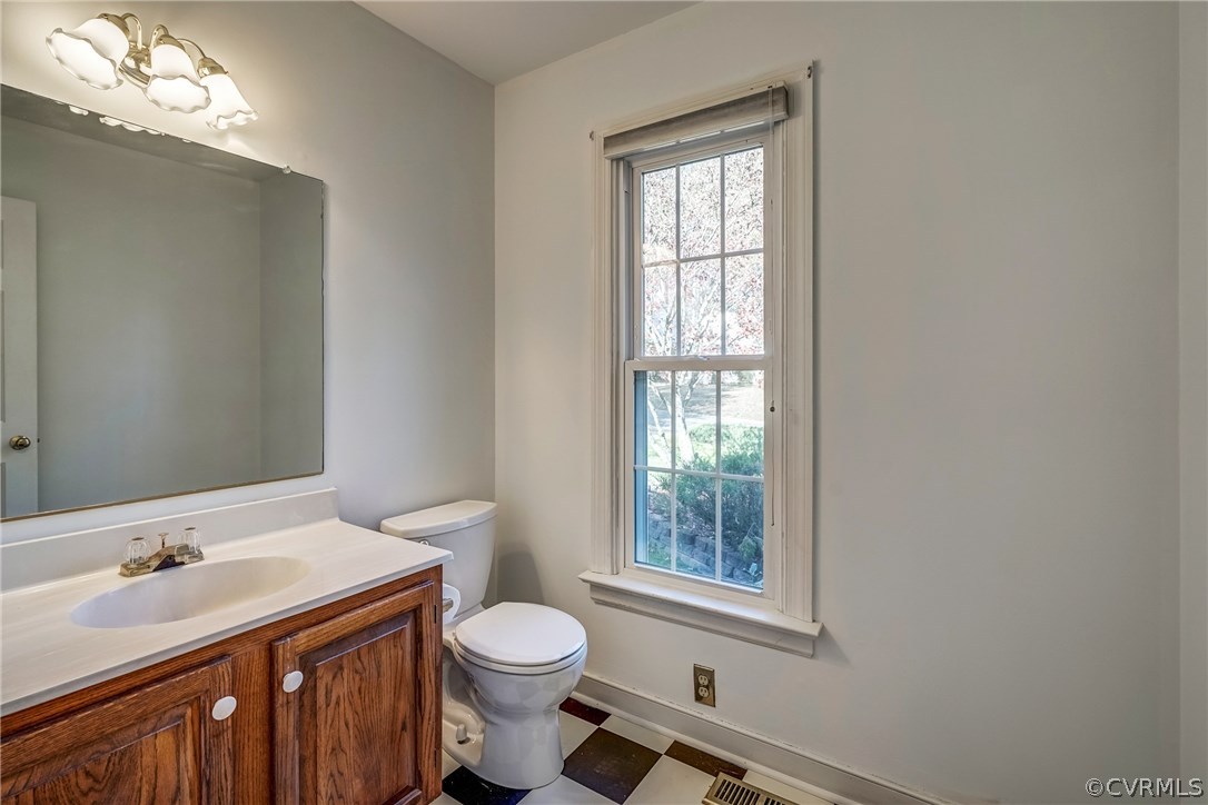 6205 Lansgate Road Midlothian, VA 23112 - Photo 10 of 50 a bathroom with a sink a toilet and a window
