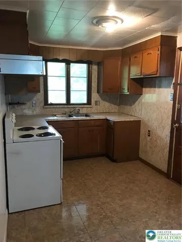a kitchen with stainless steel appliances granite countertop a sink and a stove