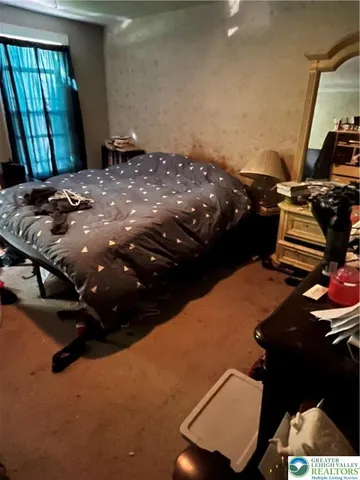 a room with furniture a flat screen tv and a large window