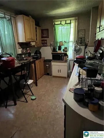 a view of a room with workspace and music instruments