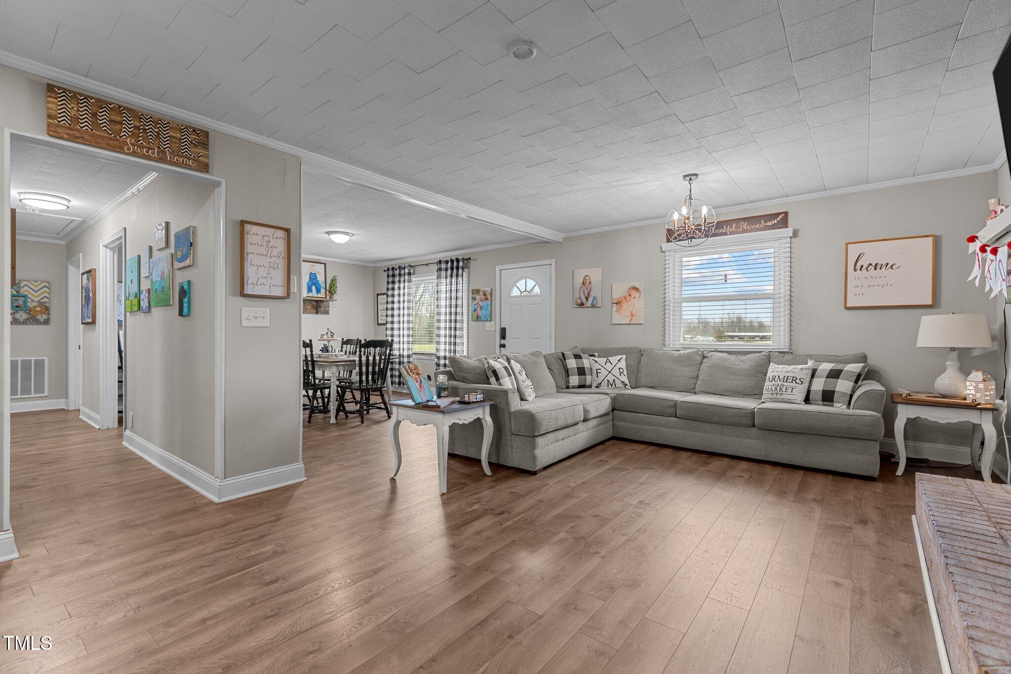 2144 Blalock Dairy Road Roxboro, NC 27574 - Photo 14 of 42 a living room with furniture and a wooden floor