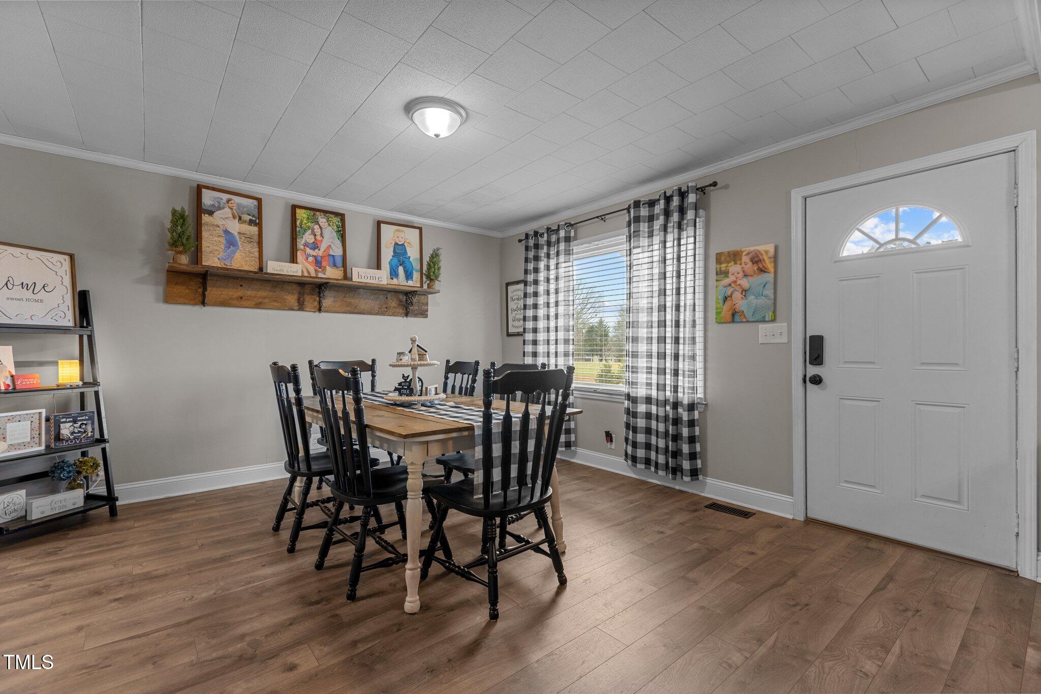 2144 Blalock Dairy Road Roxboro, NC 27574 - Photo 16 of 42 a view of a dining room with furniture and wooden floor
