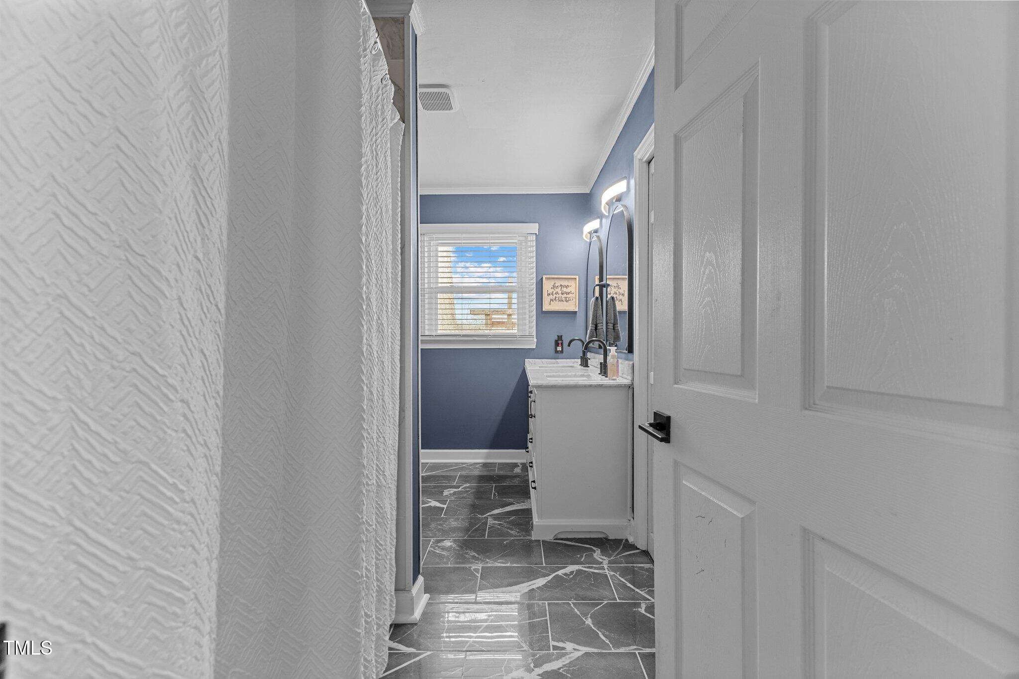 2144 Blalock Dairy Road Roxboro, NC 27574 - Photo 24 of 42 a bathroom with sink and mirror