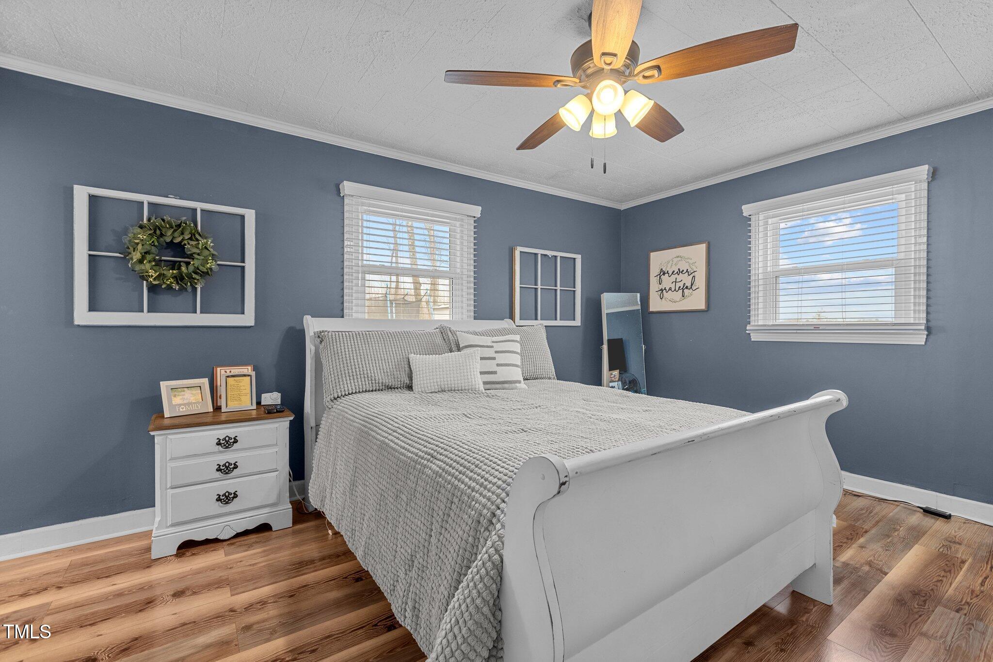 2144 Blalock Dairy Road Roxboro, NC 27574 - Photo 25 of 42 a room with a bed and a chandelier