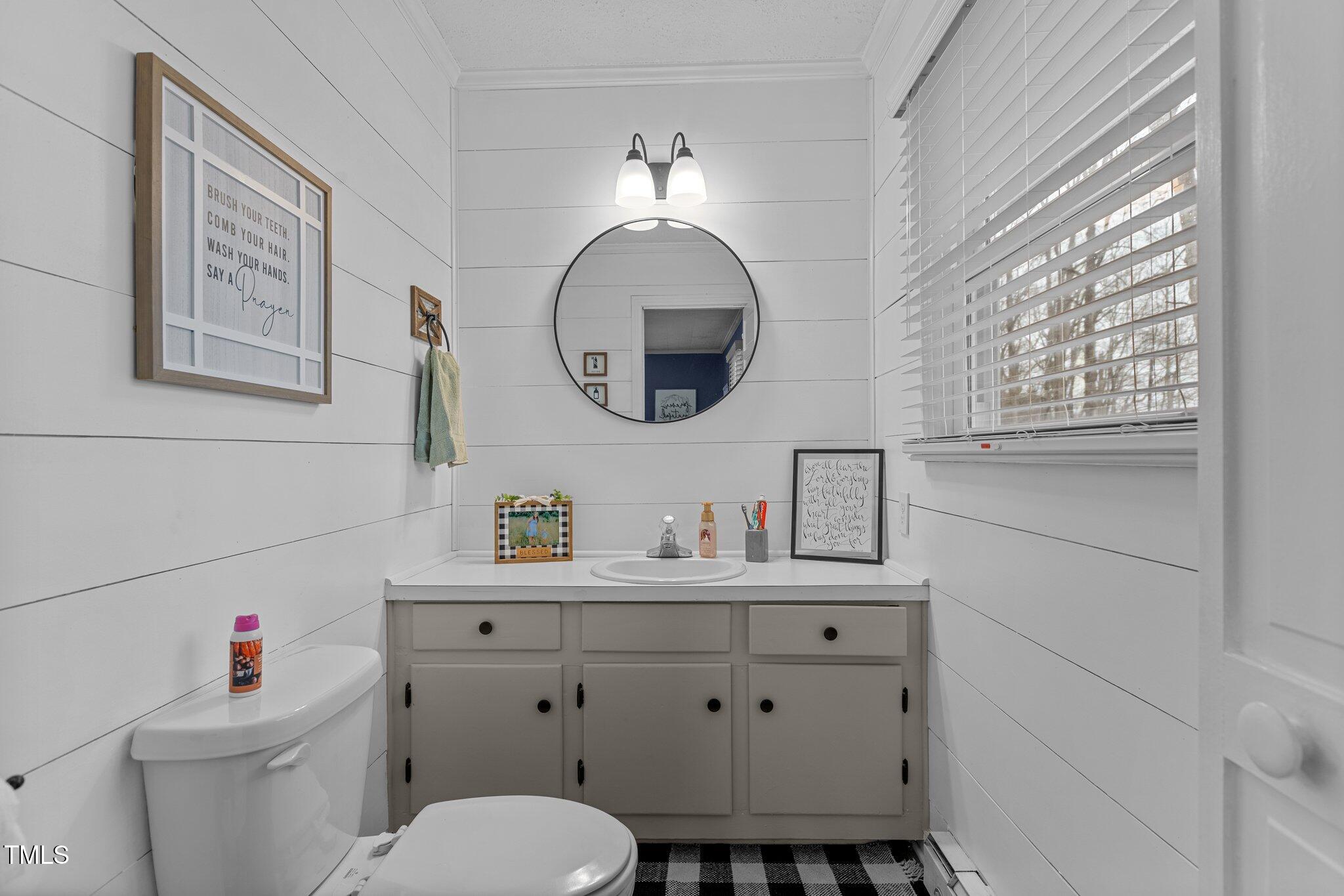 2144 Blalock Dairy Road Roxboro, NC 27574 - Photo 28 of 42 a bathroom with a toilet a sink and a mirror