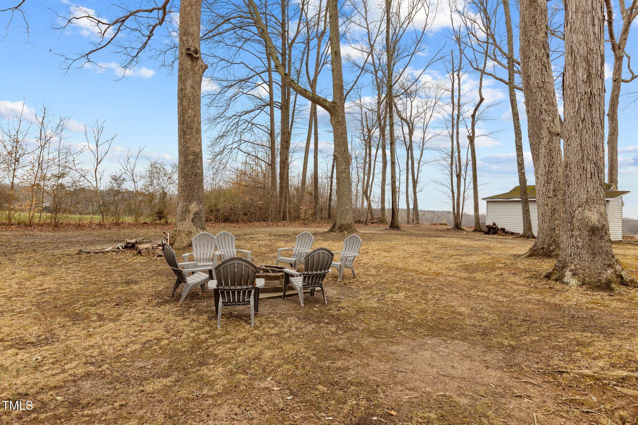 2144 Blalock Dairy Road Roxboro, NC 27574 - Photo 37 of 42 a backyard of a house with table and chairs