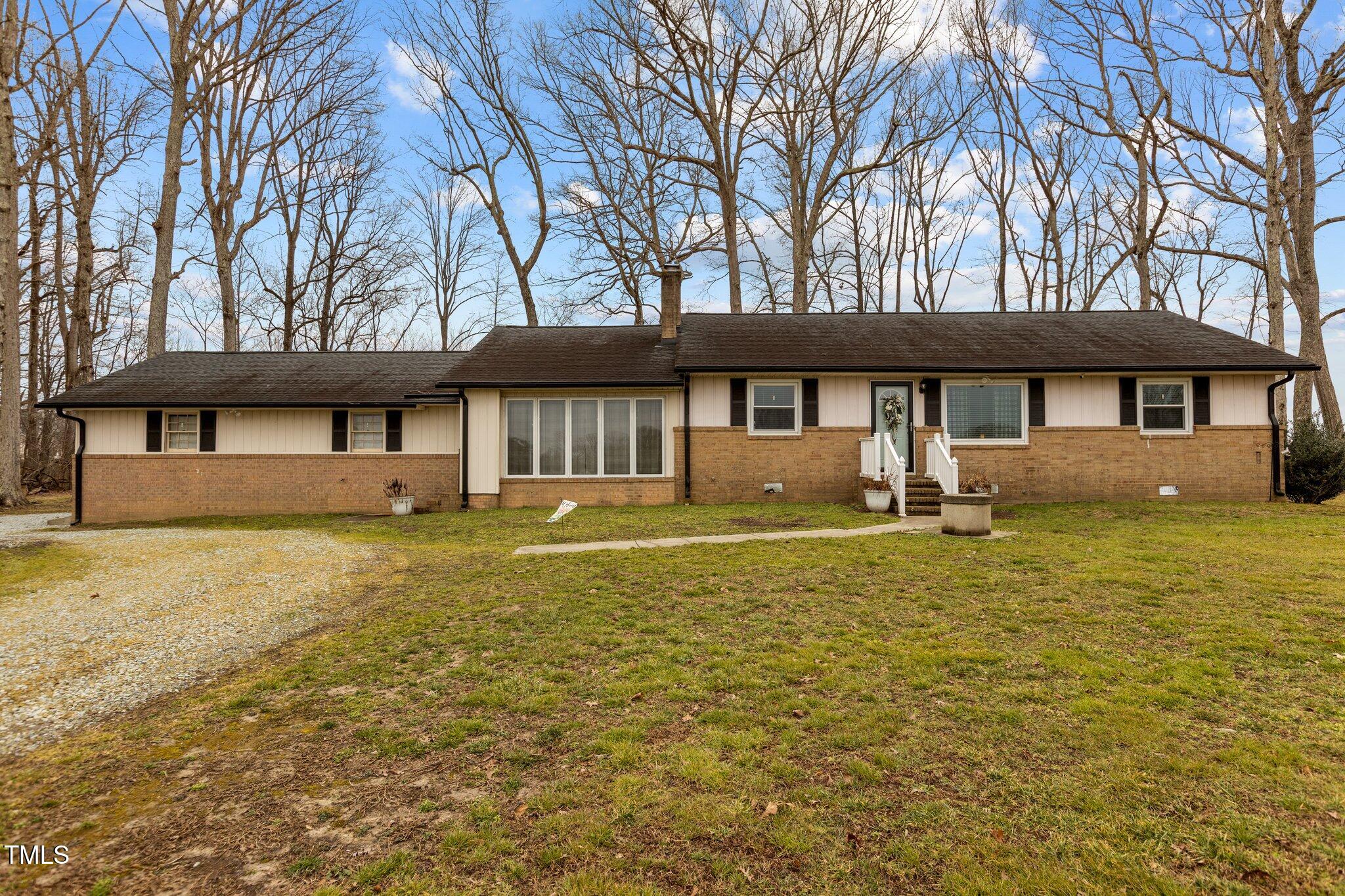 2144 Blalock Dairy Road Roxboro, NC 27574 - Photo 3 of 42 a front view of a house with a garden