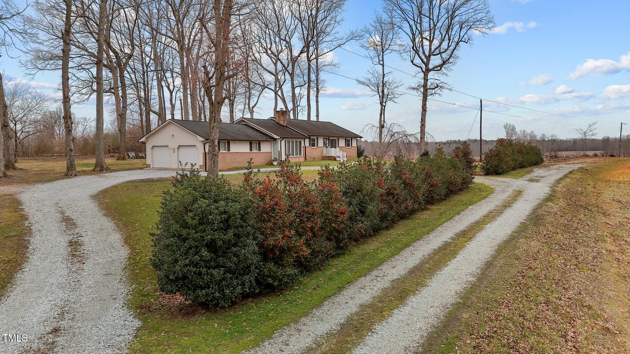 2144 Blalock Dairy Road Roxboro, NC 27574 - Photo 5 of 42 a front view of a house with a yard and lake view