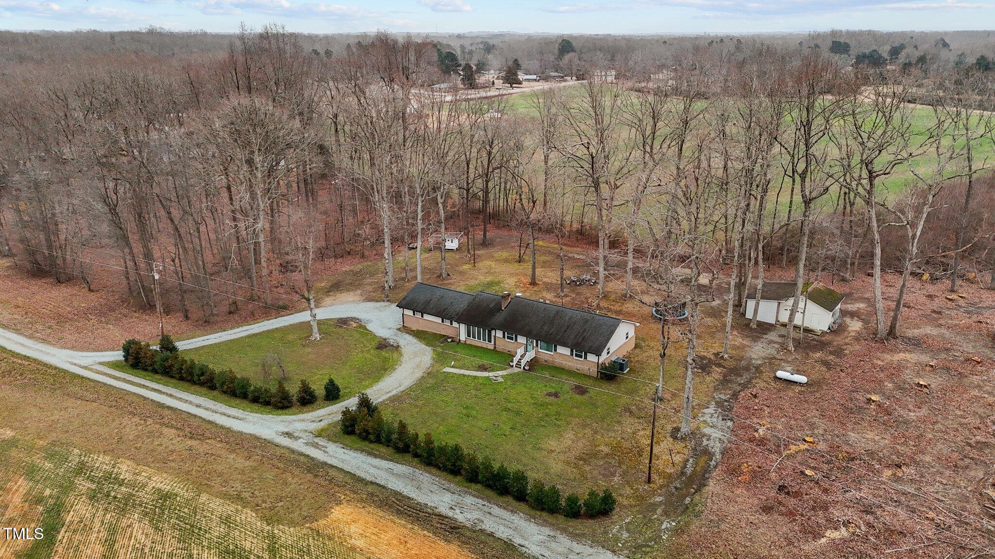2144 Blalock Dairy Road Roxboro, NC 27574 - Photo 7 of 42 a view of a backyard with table and chairs