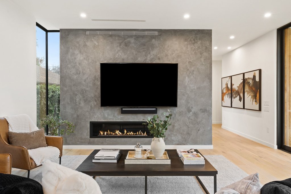 910 West Johanna Street Austin, TX 78704 - Photo 10 of 37 Living area with light wood finished floors, a lit fireplace, floor to ceiling windows, recessed lighting, and an accent wall