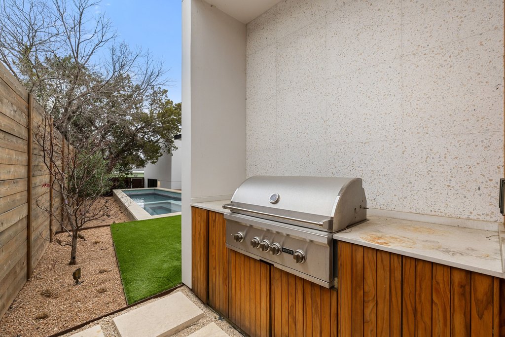 910 West Johanna Street Austin, TX 78704 - Photo 36 of 37 Fenced backyard with a patio area, an outdoor pool, and an outdoor kitchen
