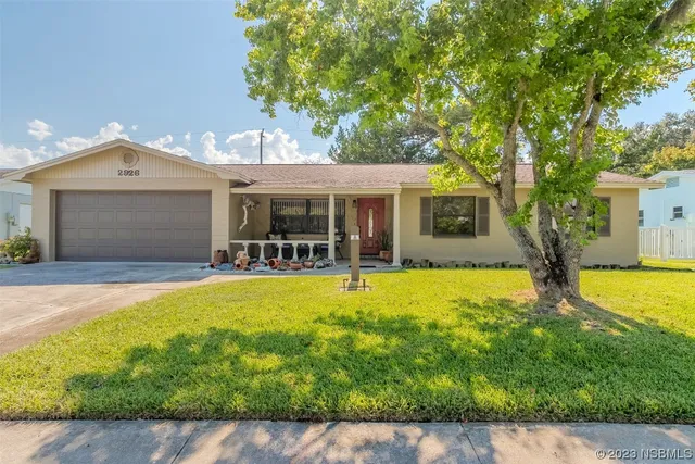 a view of a house with swimming pool and a yard