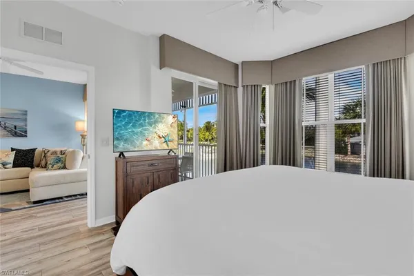 a bedroom with a large bed and a dresser