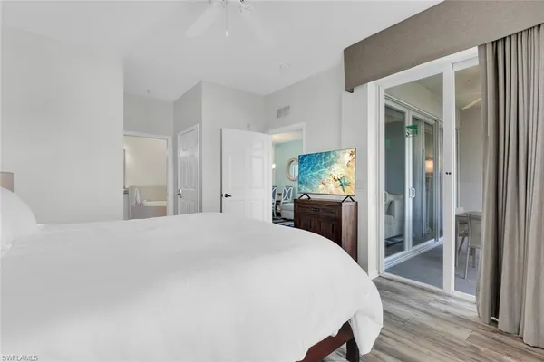 a bedroom with a bed and a large mirror