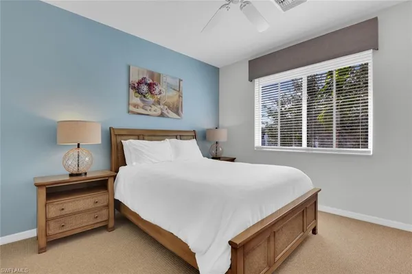 a bedroom with a bed and a night stand