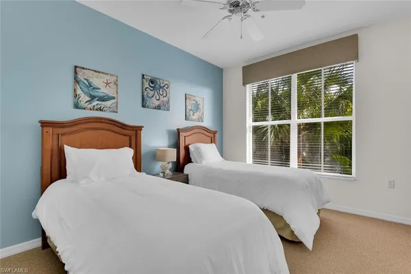 a bedroom with two beds and a window