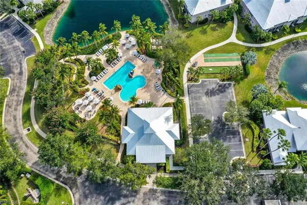 an aerial view of a house with a yard and swimming pool