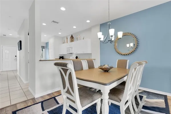 a view of a dining room with furniture and a chandelier
