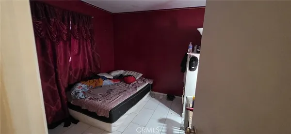 a wooden bench sitting in a bedroom next to a wooden cabinet