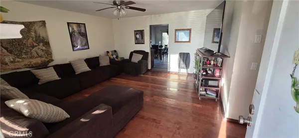 a living room with furniture and a book shelf