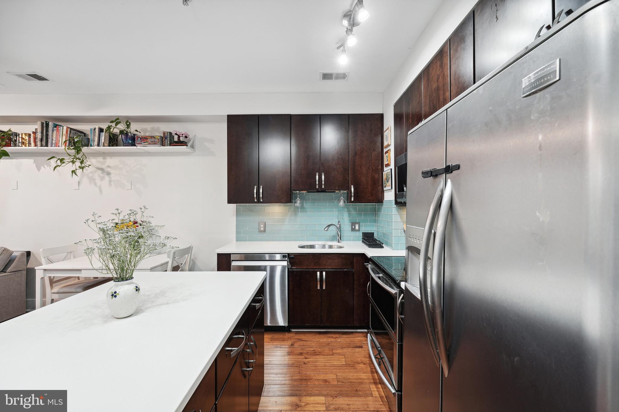 245 15th Street Southeast, Unit 204 Washington, DC 20003 - Photo 7 of 30 a kitchen with kitchen island a sink stove and refrigerator
