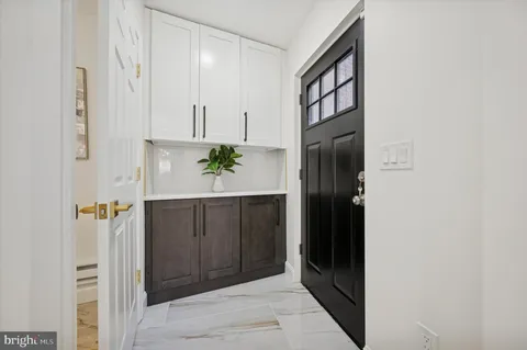 a view of an entryway with wooden floor