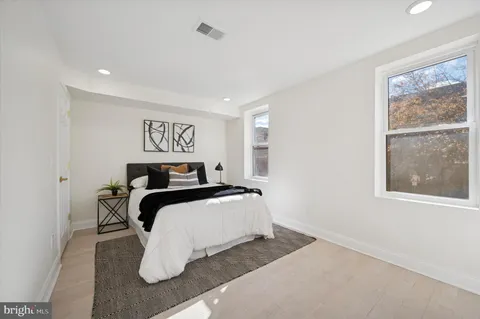 a bedroom with a bed and a large window