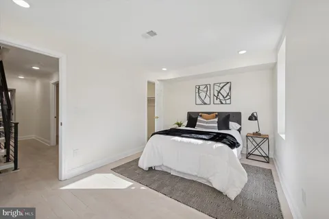 a bedroom with a bed and a painting