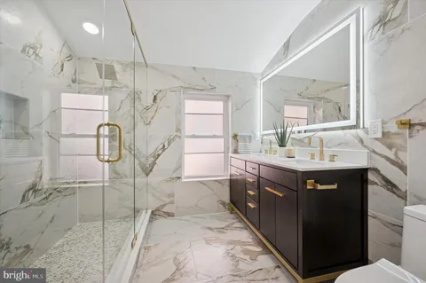 a bathroom with double vanity and a sink