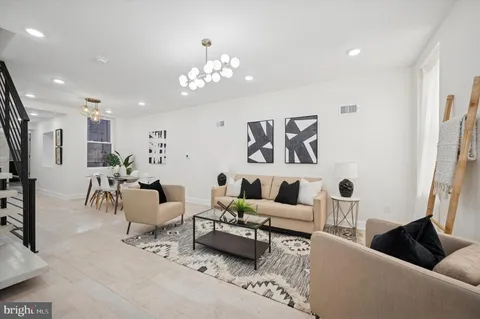 a living room with furniture and a chandelier