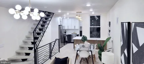a view of a dining room with furniture and a chandelier