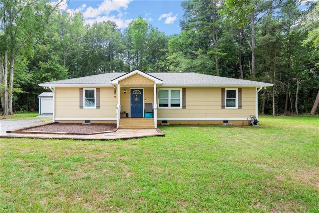 1345 Laboon Road Monroe, GA 30655 - Photo 1 of 1 a front view of a house with a yard and trees