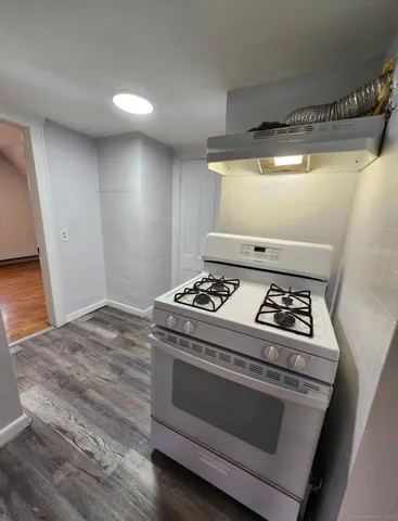 a stove top oven sitting inside of a kitchen
