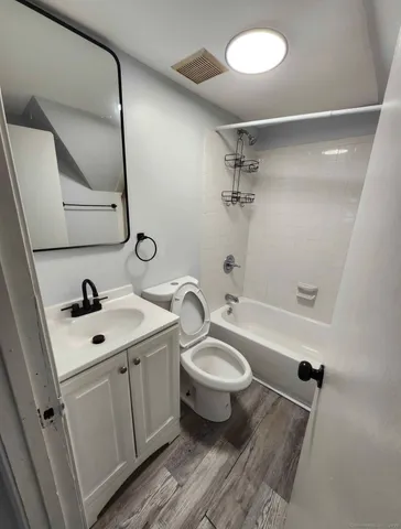a bathroom with a sink mirror vanity and toilet