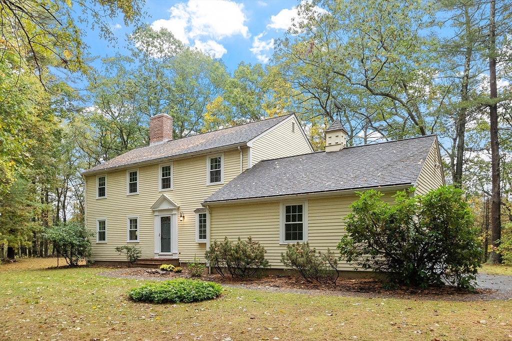 31 Herrick Road Boxford, MA 01921 - Photo 1 of 40 a view of a yard in front of a house with plants and large tree
