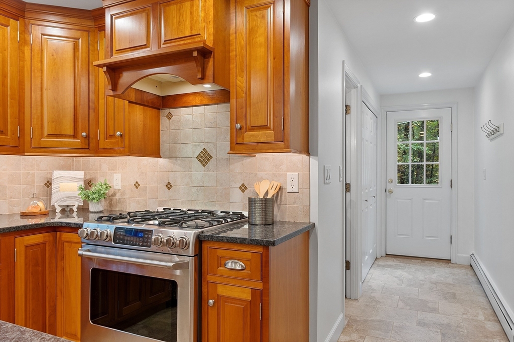 31 Herrick Road Boxford, MA 01921 - Photo 11 of 40 a kitchen with granite countertop cabinets stainless steel appliances and a counter space