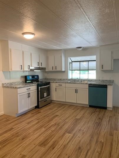 3041 Fm 671 Road Luling, TX 78648 - Photo 1 of 1 a kitchen with stainless steel appliances granite countertop a stove top a sink dishwasher a refrigerator and white cabinets with wooden floor