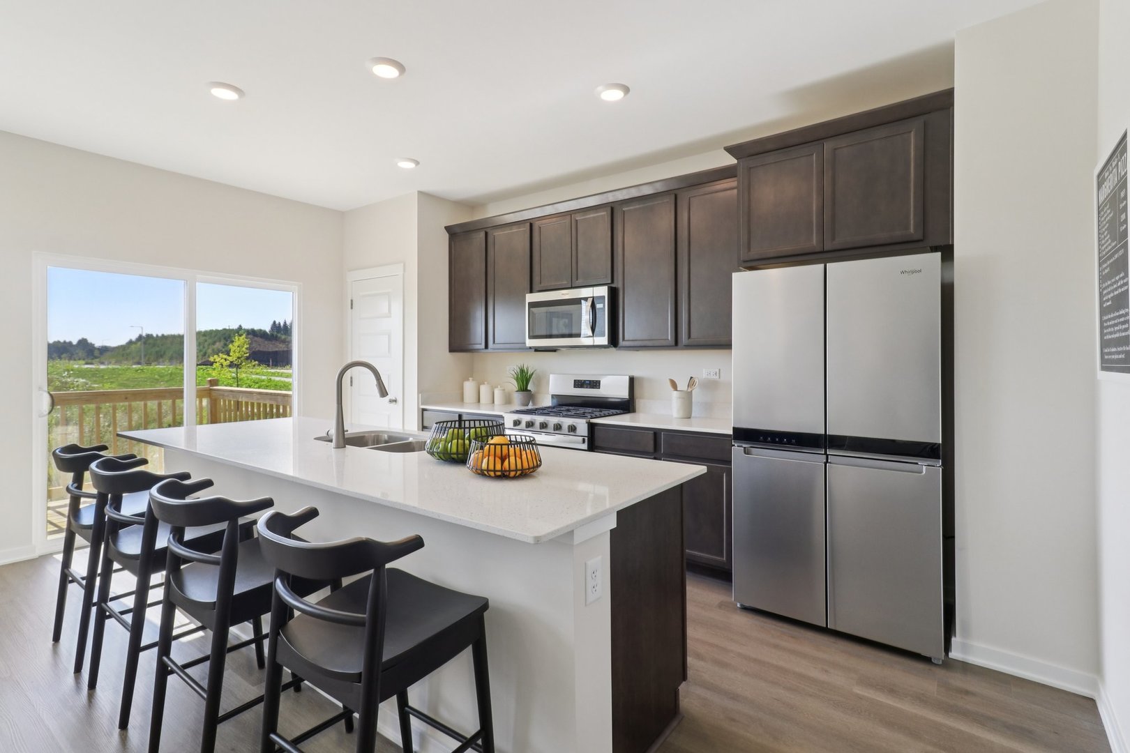 1748 Stable Lane Aurora, IL 60503 - Photo 13 of 34 a kitchen with stainless steel appliances granite countertop a refrigerator a stove a sink a dining table and chairs