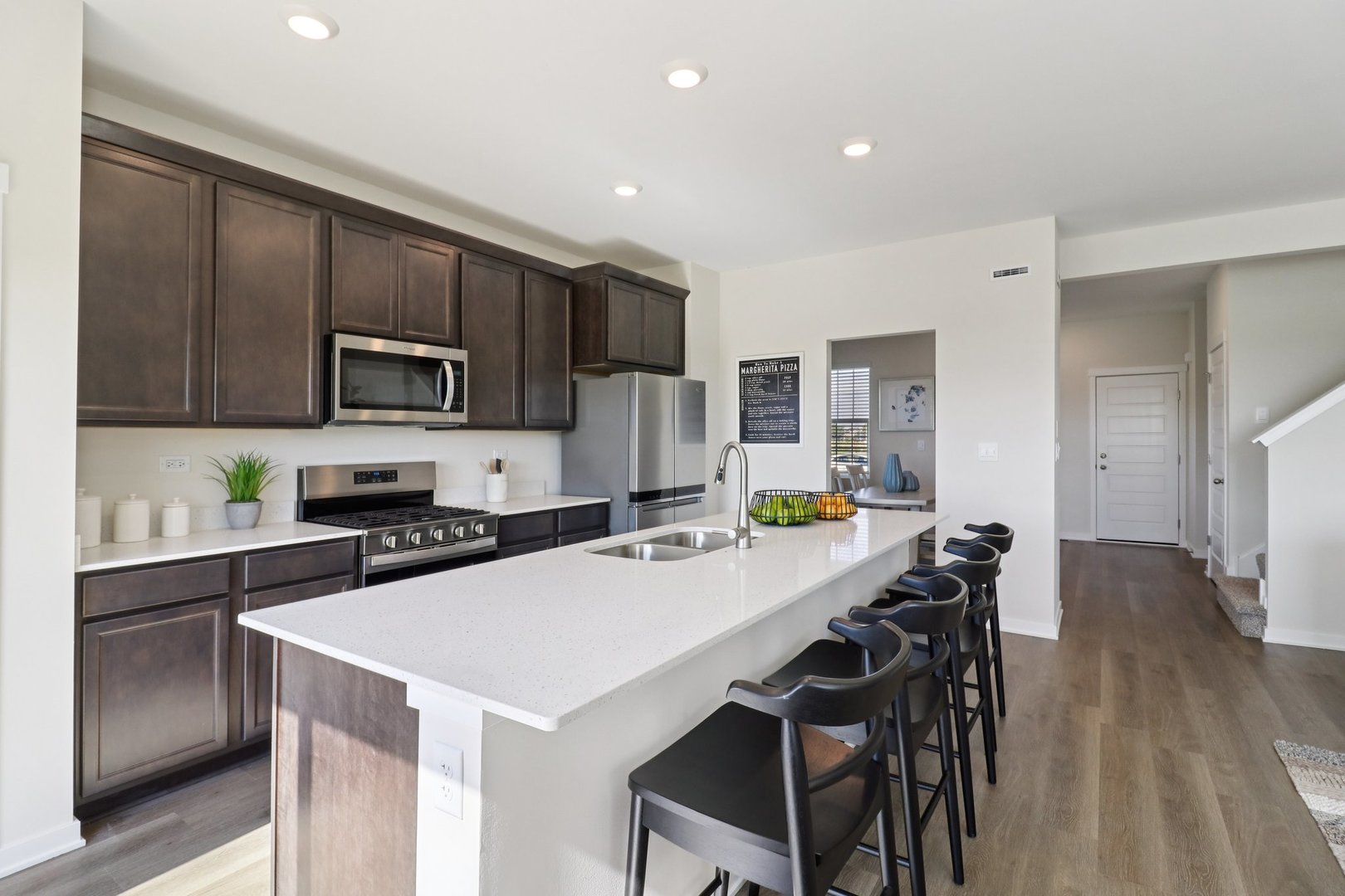 1748 Stable Lane Aurora, IL 60503 - Photo 14 of 34 a kitchen with a dining table chairs and refrigerator