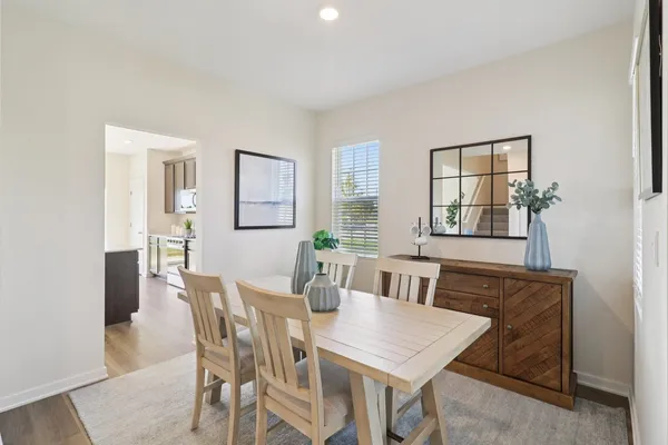 a view of a dining room with furniture and window