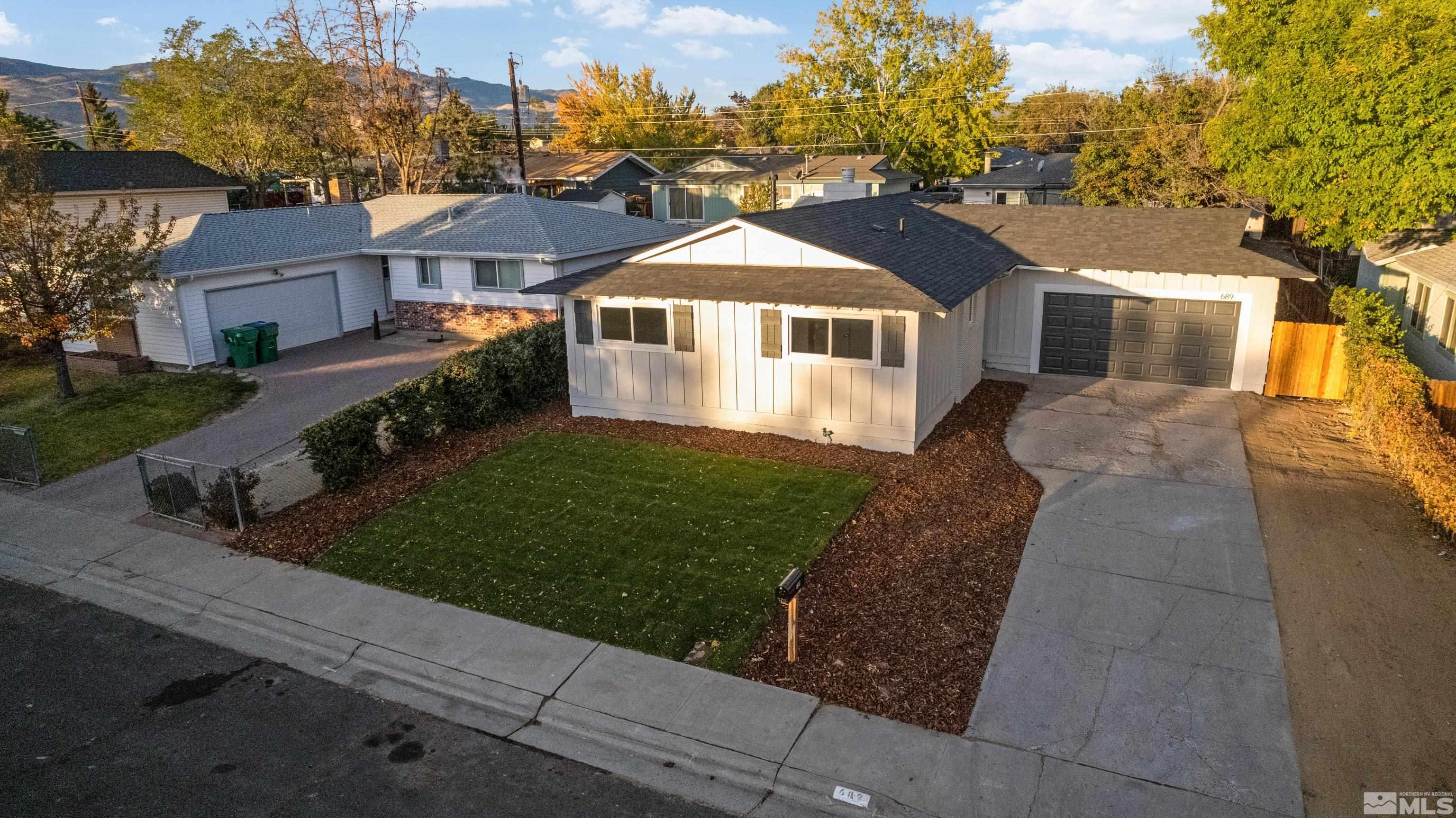 689 Beldon Way Reno, NV 89503 - Photo 1 of 30 a front view of a house with a yard and garage