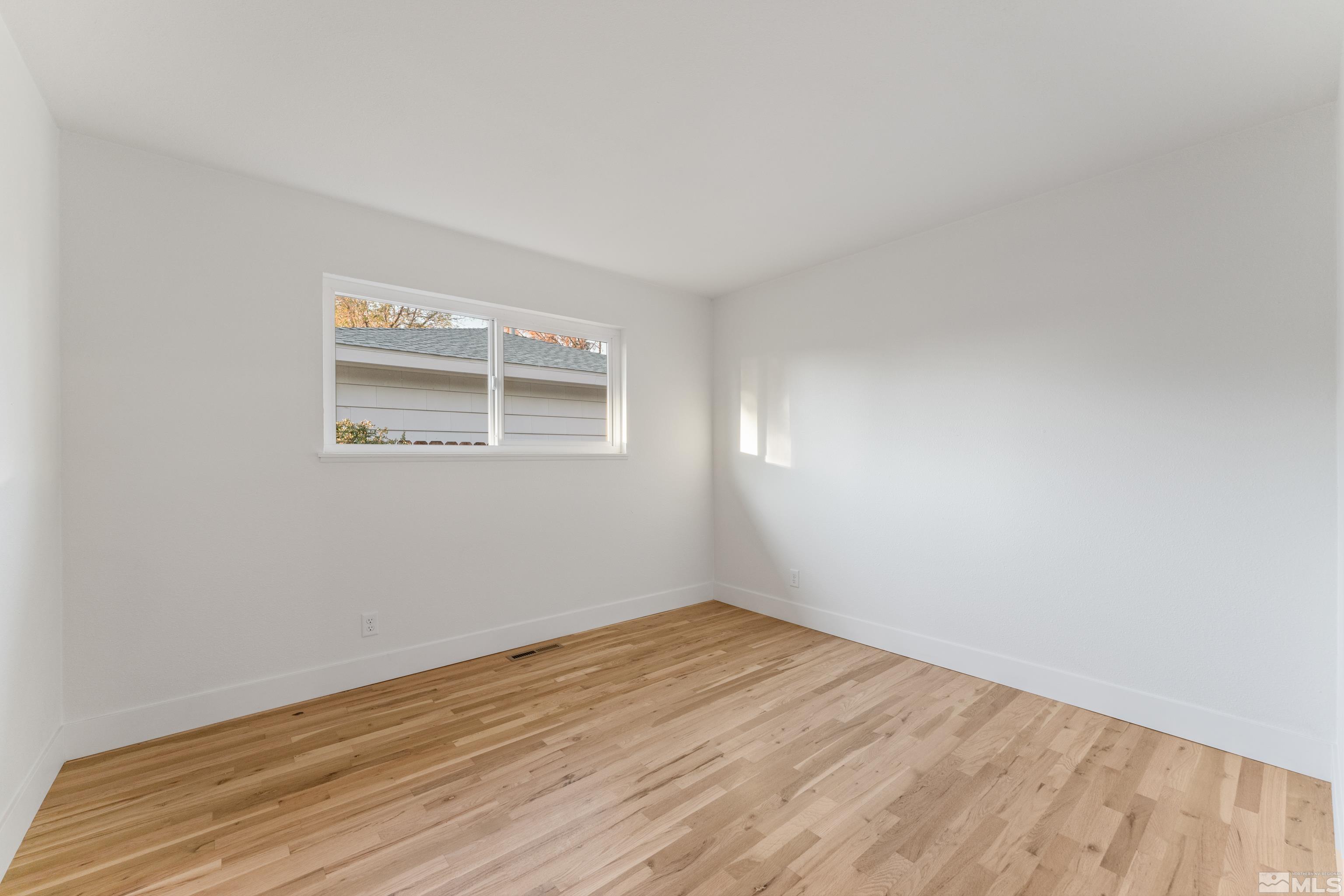 689 Beldon Way Reno, NV 89503 - Photo 12 of 30 an empty room with wooden floor and windows