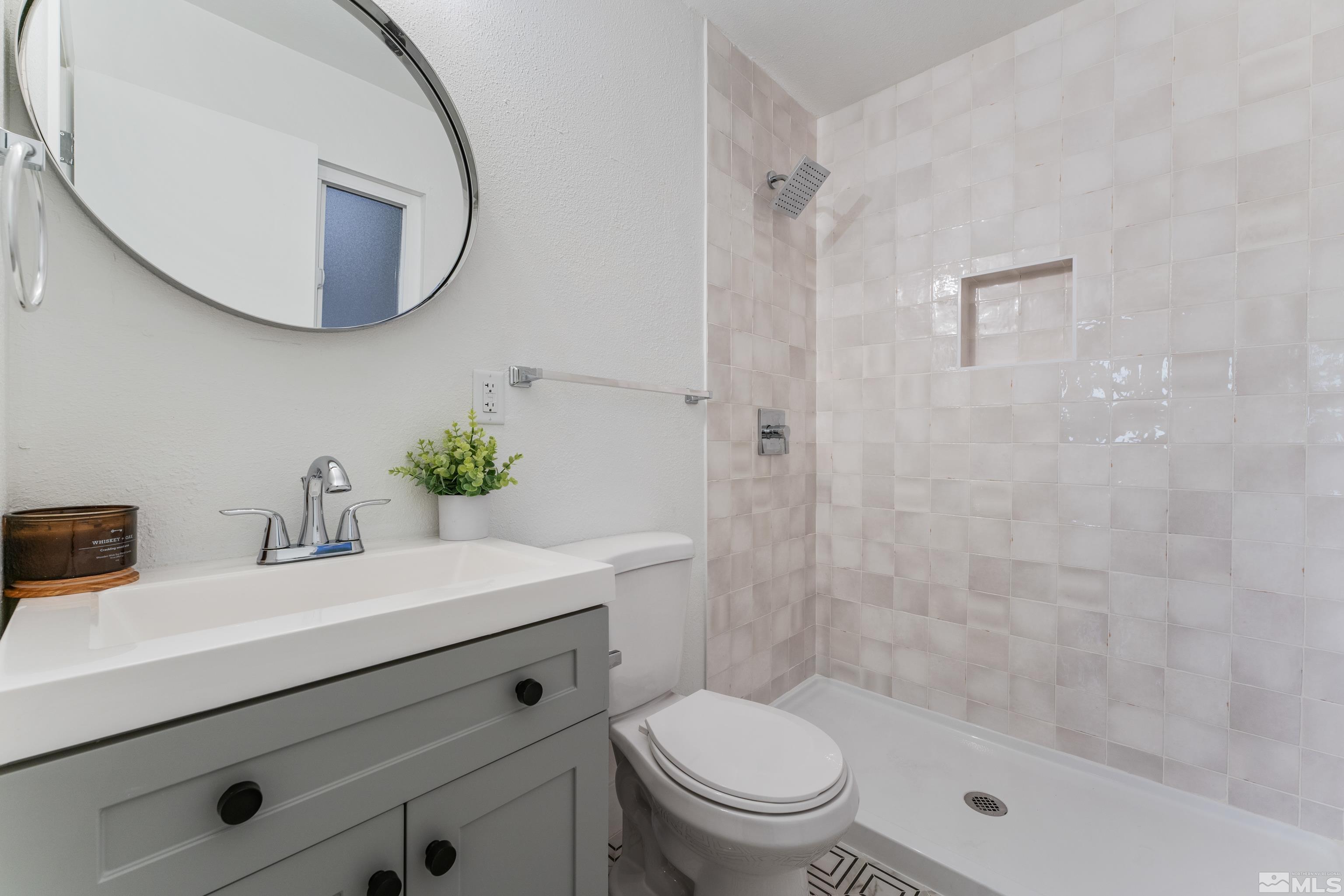 689 Beldon Way Reno, NV 89503 - Photo 14 of 30 a bathroom with a sink a toilet and a mirror