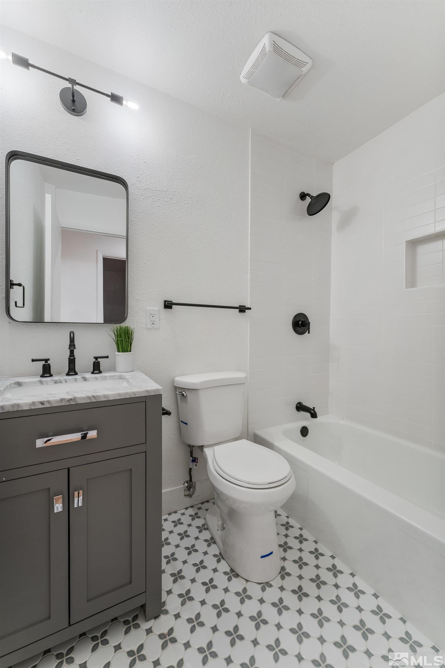 689 Beldon Way Reno, NV 89503 - Photo 20 of 30 a bathroom with a sink toilet a mirror and shower