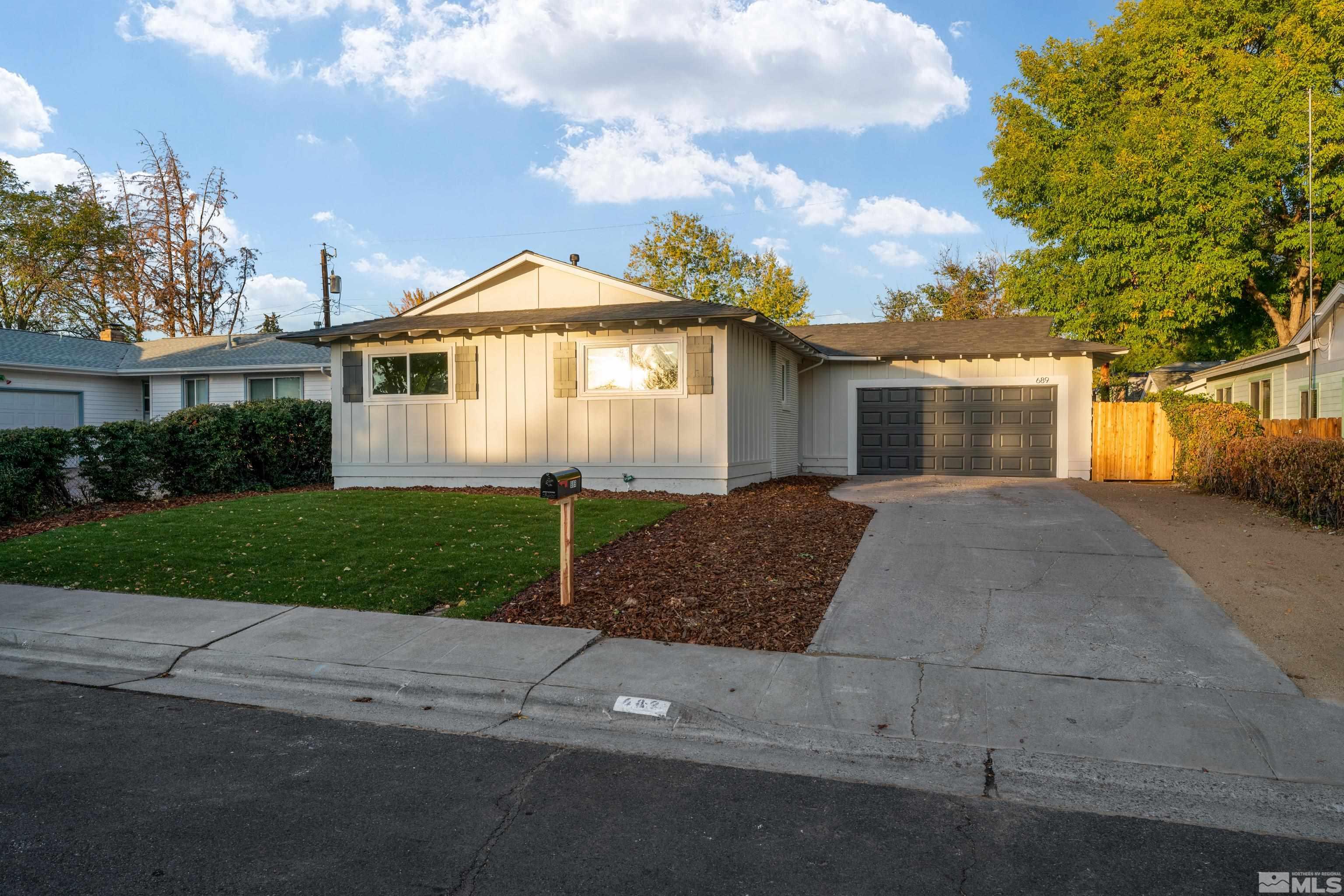 689 Beldon Way Reno, NV 89503 - Photo 25 of 30 a front view of a house with a yard and garage