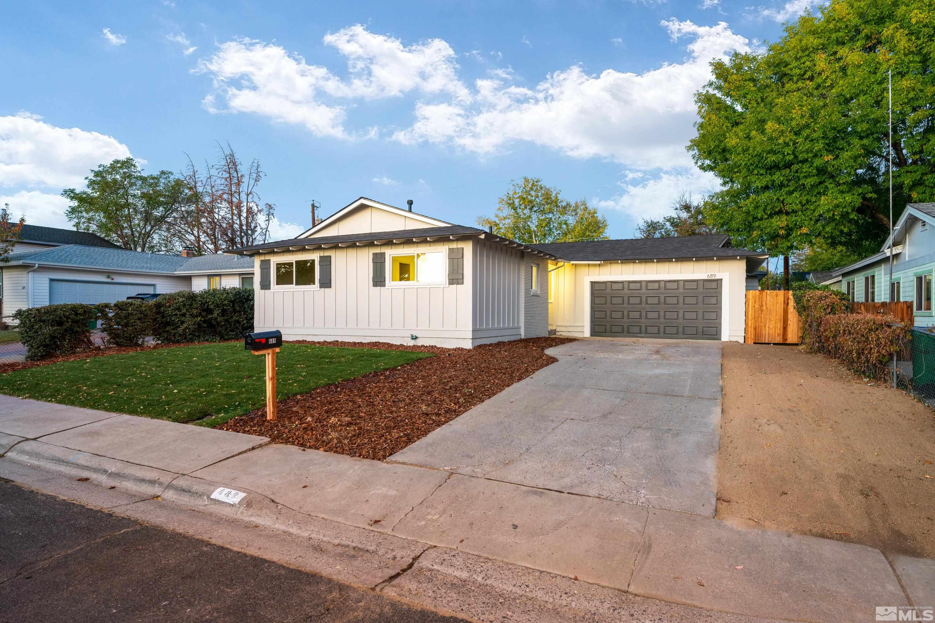 689 Beldon Way Reno, NV 89503 - Photo 29 of 30 a front view of a house with a yard and garage