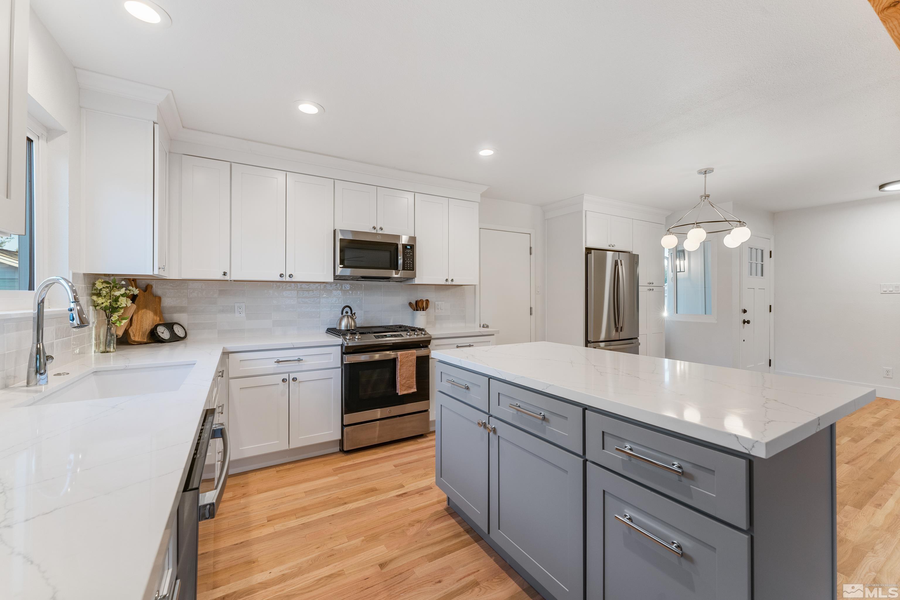 689 Beldon Way Reno, NV 89503 - Photo 3 of 30 a kitchen with a sink stove and cabinets