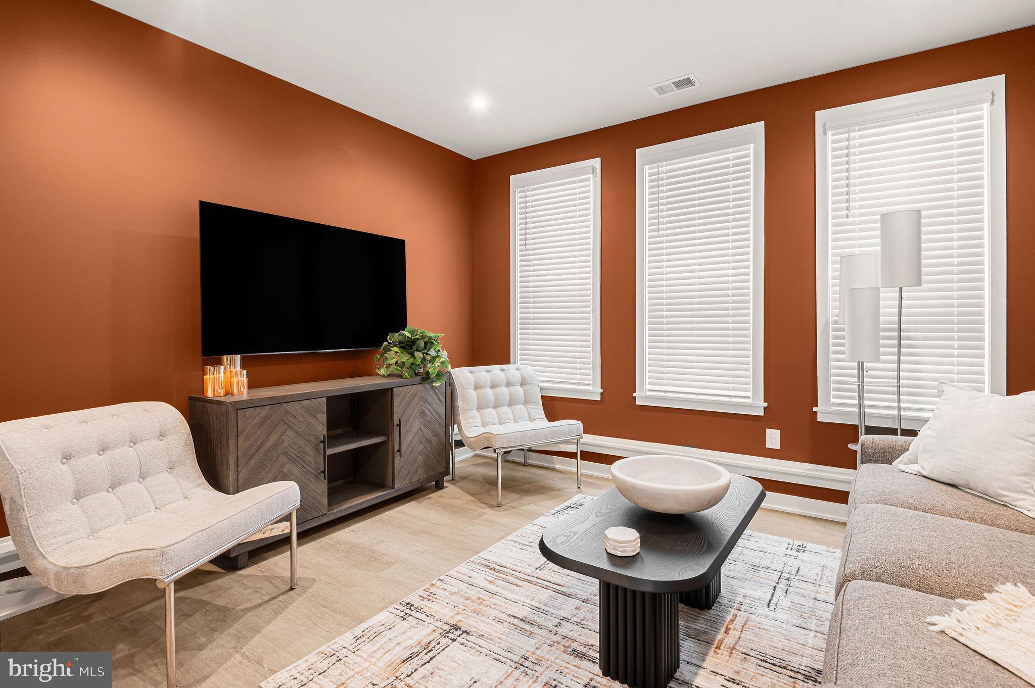 26 South York Road, Unit 101 Hatboro, PA 19040 - Photo 11 of 56 a living room with furniture and a flat screen tv