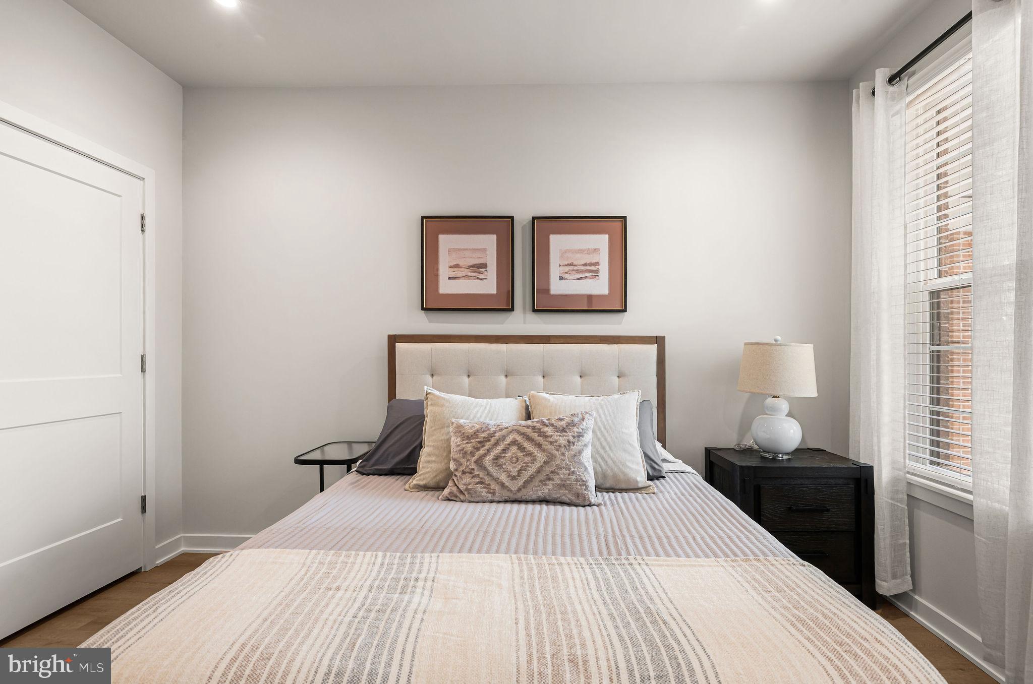 26 South York Road, Unit 101 Hatboro, PA 19040 - Photo 19 of 56 a bedroom with a bed and night stand